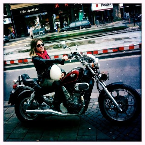 Christiane Hütter with sun glasses sitting on a motorcycle
