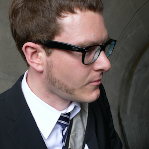Ulf Burmeyer seen from his right side with glasses and suit