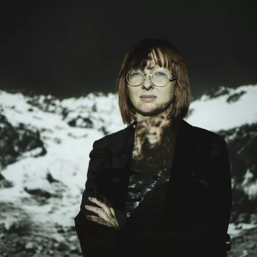 Portrait of Theresa Schubert with video projection behind