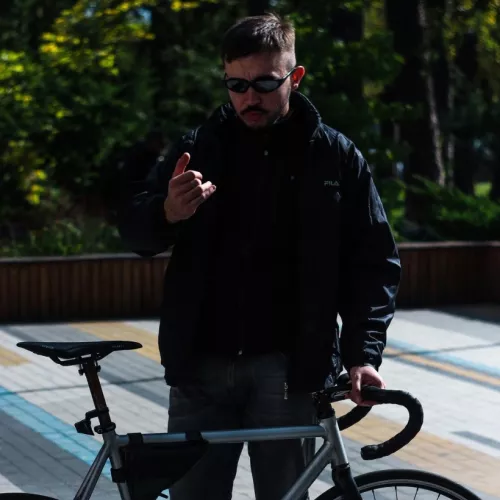 Beautiful boy with cool bicycle and black techno glasses 