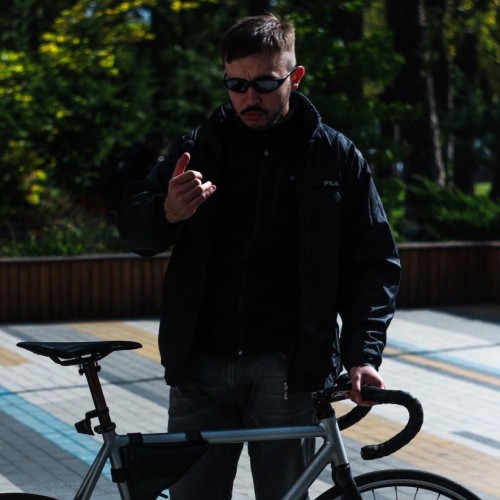 Beautiful boy with cool bicycle and black techno glasses 