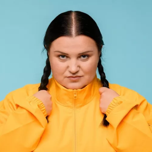 alyona alyona wearing a track suit with determined, sincere face expression