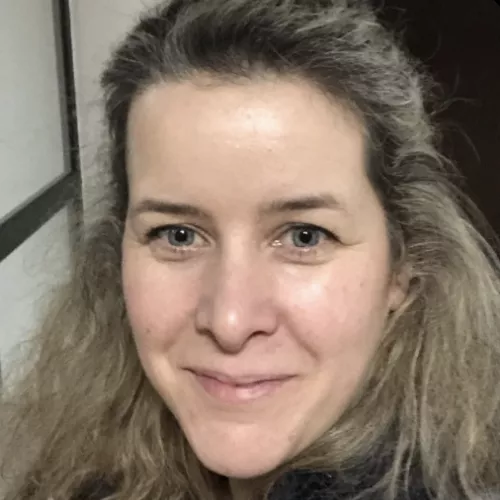 A portrait of Rebekka smiling optimistically into the camera
