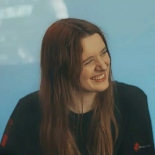 A picture of Carolin, long-hair brunette, smiling.