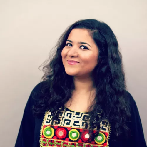 Picture of Hera Hussain. Black curly hair. Almond complexion. 