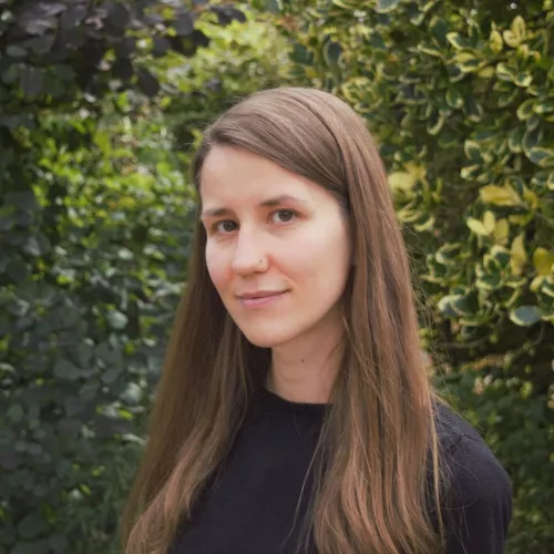 sandra wachter in front of a bush