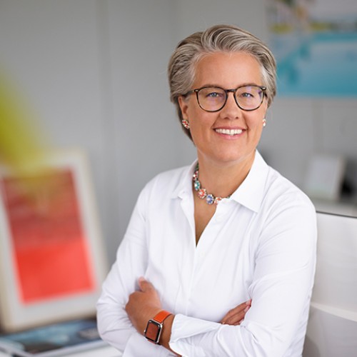 Auf dem Bild sieht man die Vorstandsvorsitzende der Schufa, Tanja Birkholz. Sie trägt eine weiße Bluse und eine Brille. 