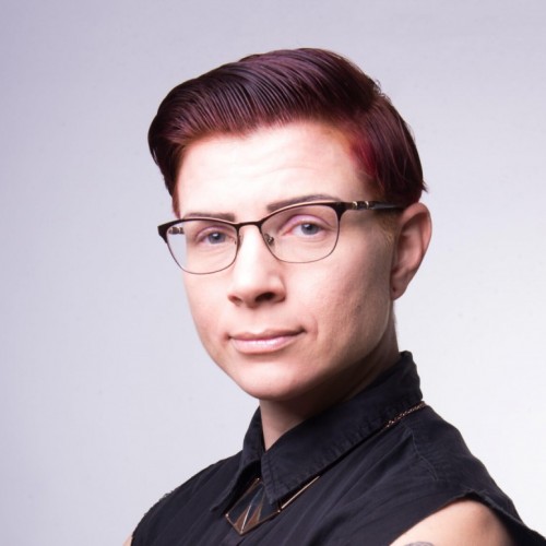 picture of a white presenting nonbinary person with glasses