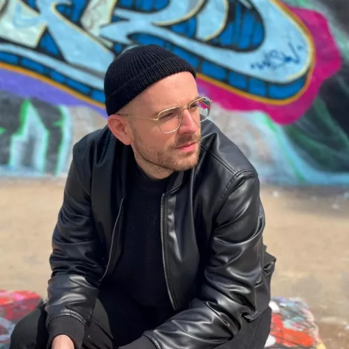 picture of claudio wearing a black leather jacked and hat