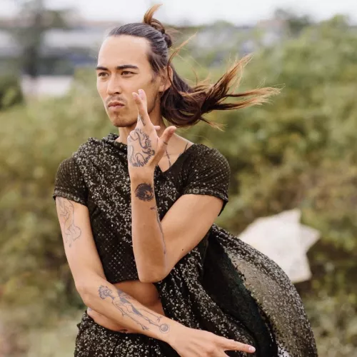 Picture of ben dancing with bushes in the background